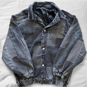black and gray patchwork faux-denim jacket with elasticated cuffs and hem
